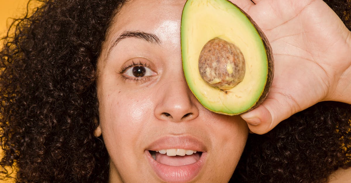 A close up of a woman holding a banana