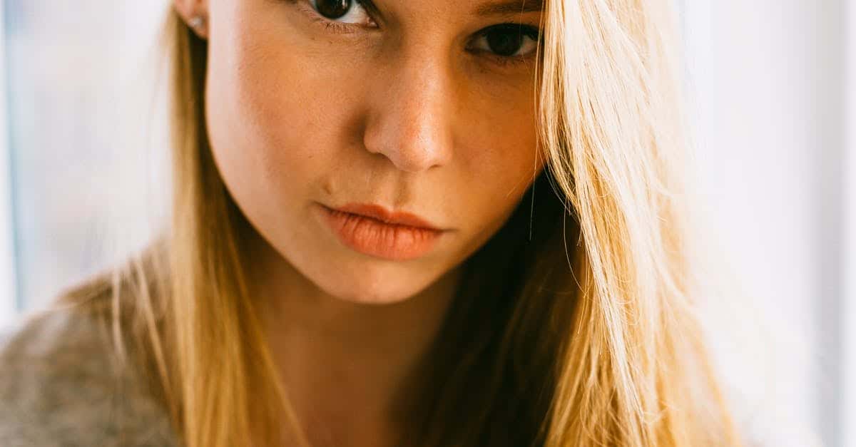 A close up of a woman with long hair looking at the camera