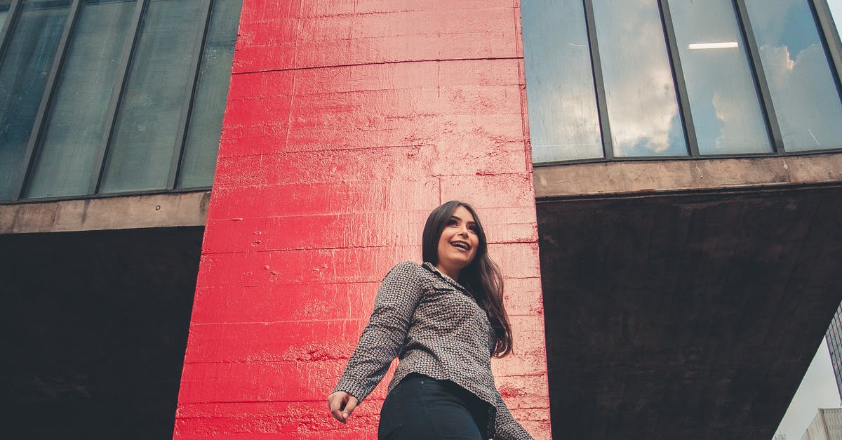 A person sitting in front of a brick building