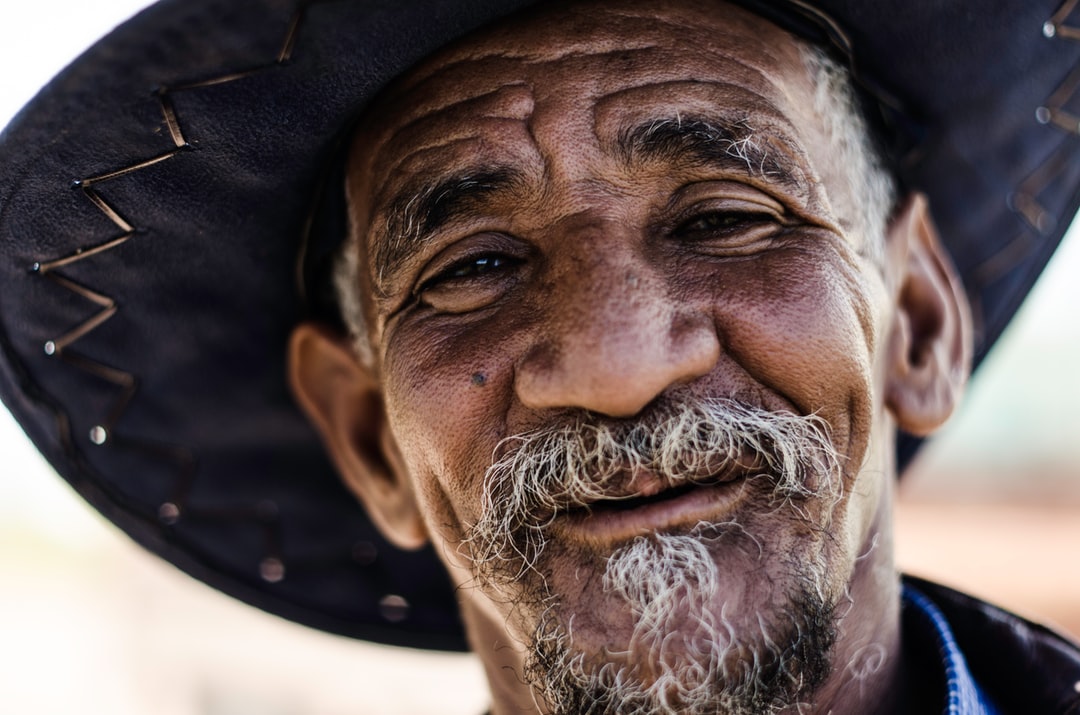 A close up of a man wearing a hat