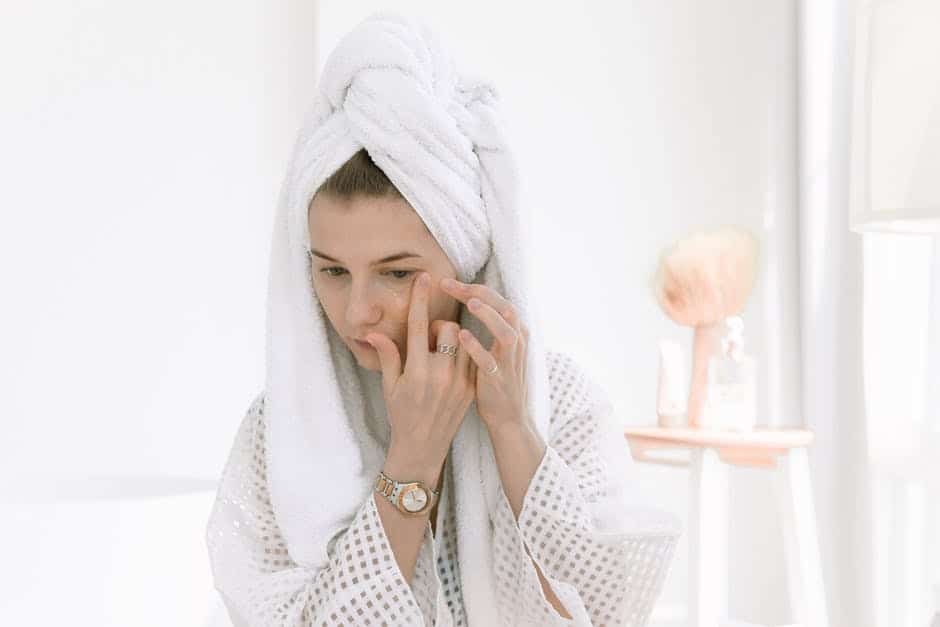 A woman wearing a hat talking on a cell phone