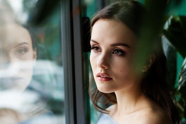 A woman looking at window