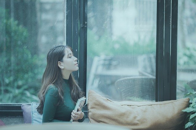 A woman sitting in front of a window