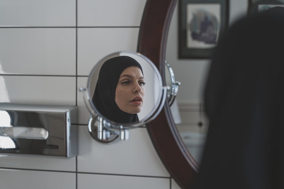 A person sitting in front of a mirror posing for the camera