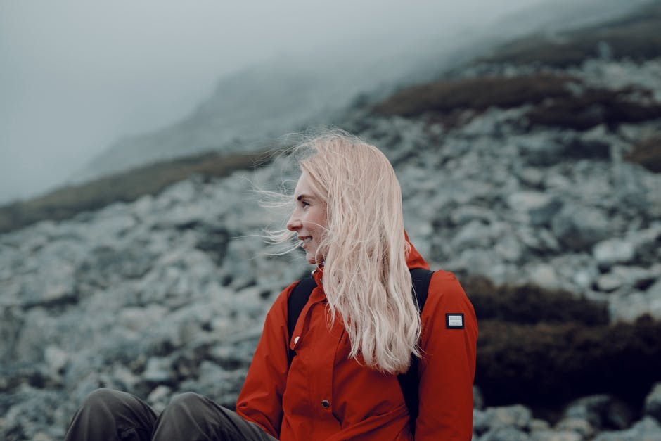 A person standing in front of a mountain