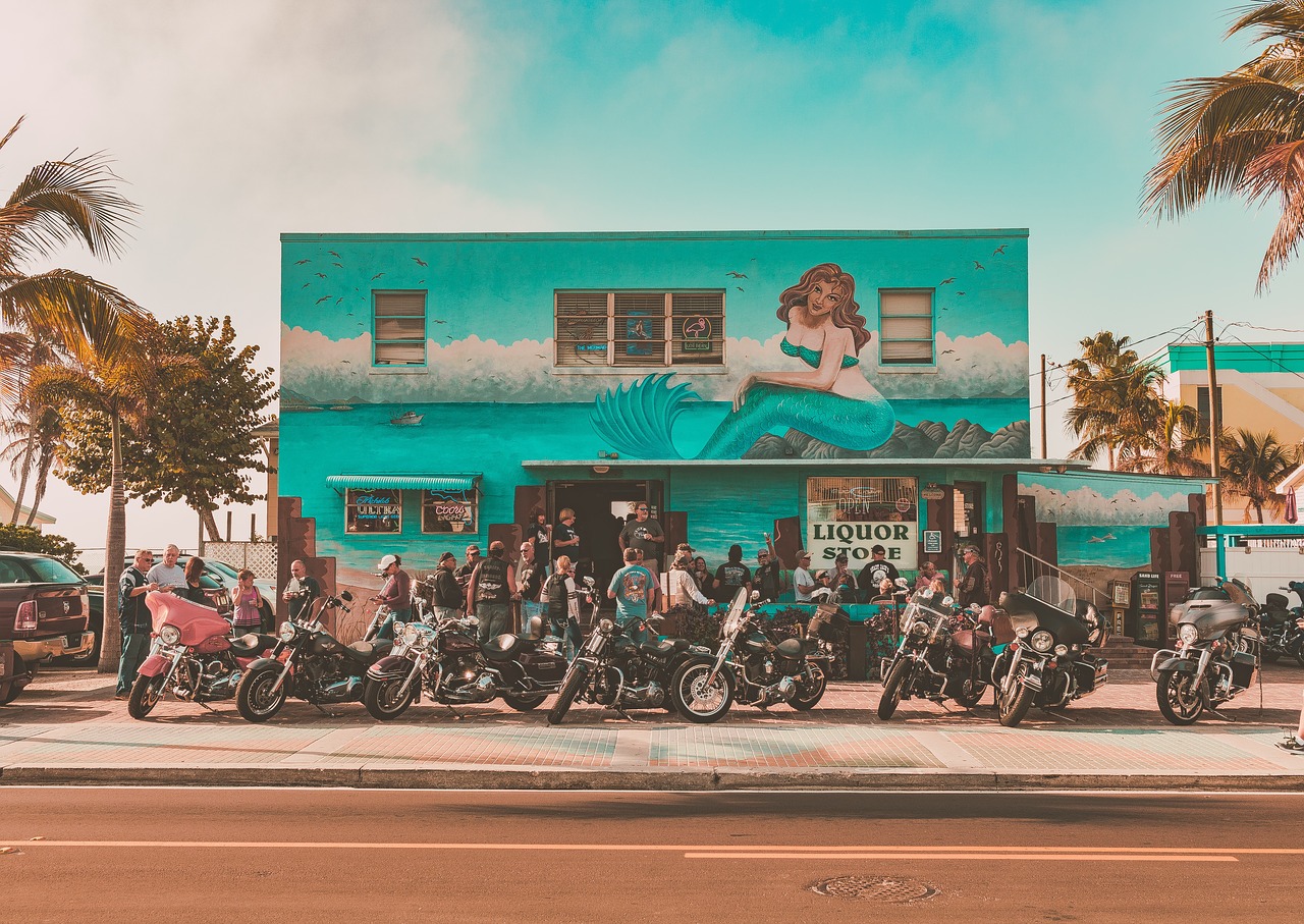 A group of people on a motorcycle in front of a store